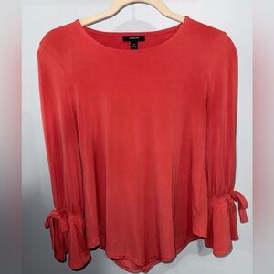 I am selling a Alfani with a V bottom cut and bow sleeves